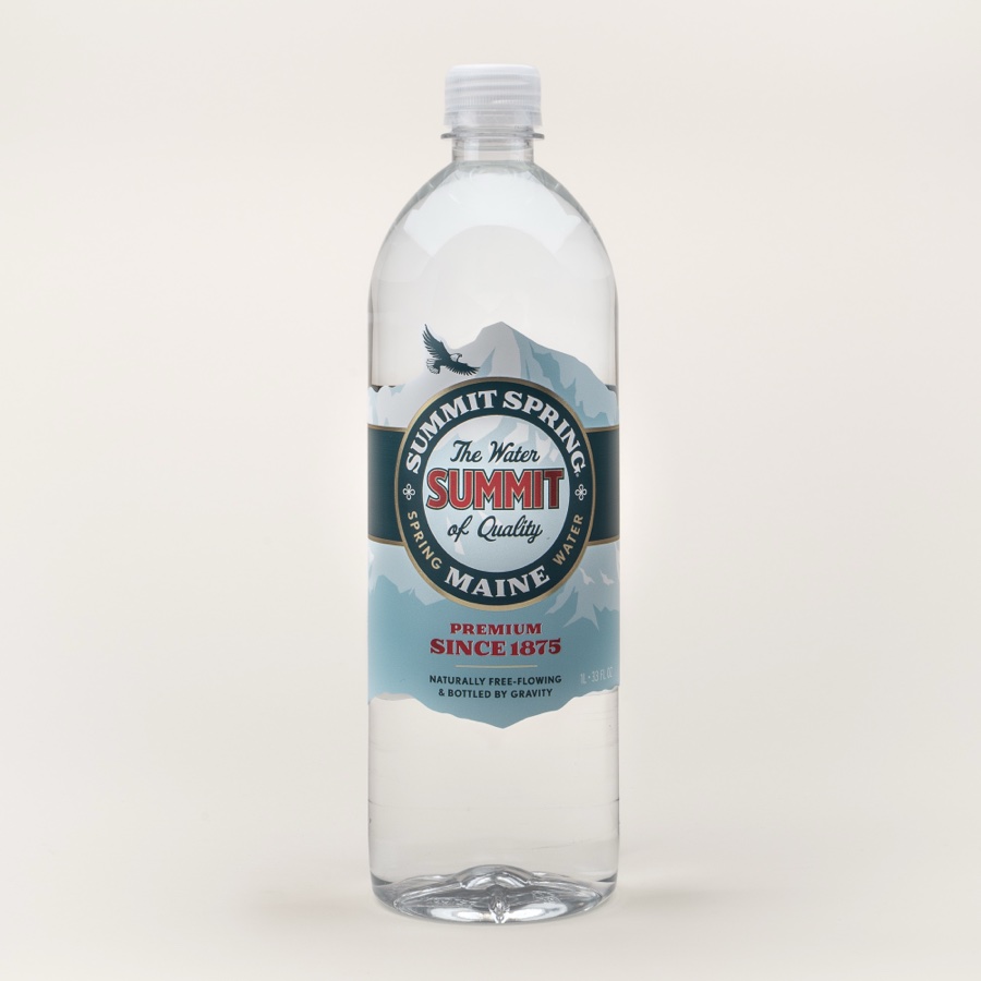 A one-litre bottle of spring water on a plain background